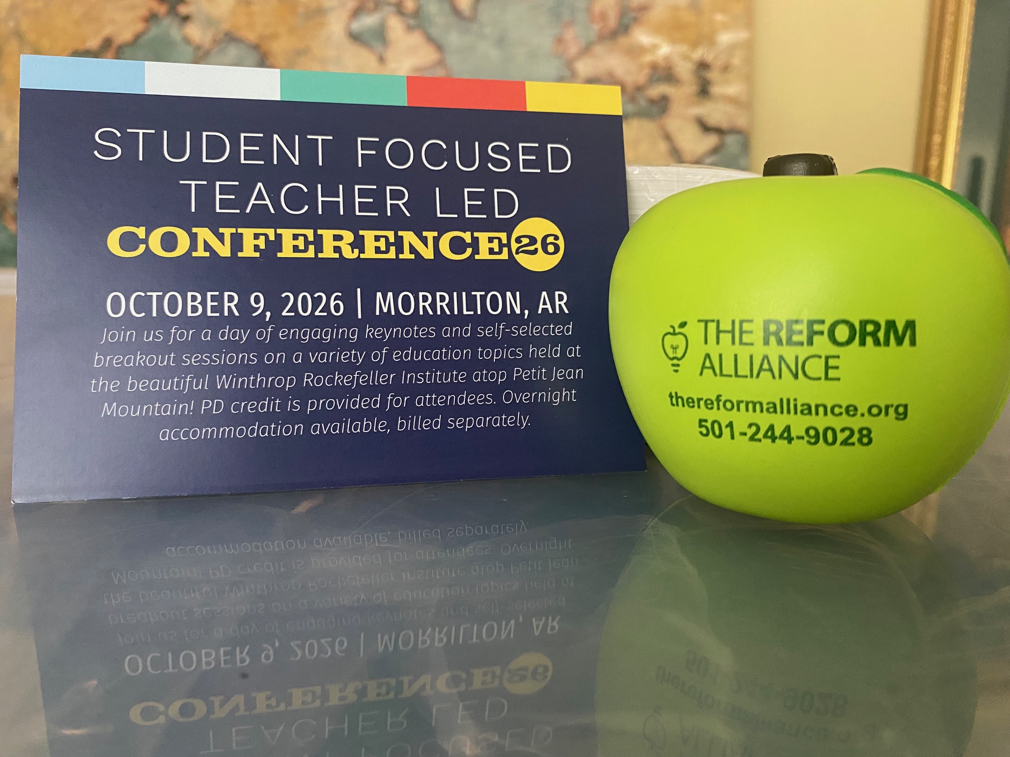 SFTL 2026 A conference card and green stress apple read STUDENT FOCUSED TEACHER LED CONFERENCE 26, October 9, 2026, Morrilton, AR and THE REFORM ALLIANCE with a phone number and website.